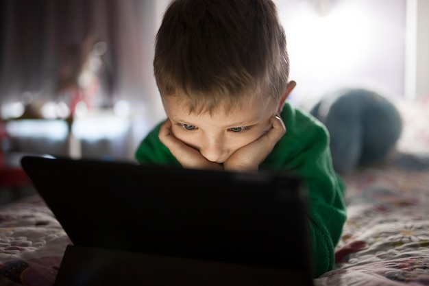 adorable-boy-watching-film-tablet_23-2147781871